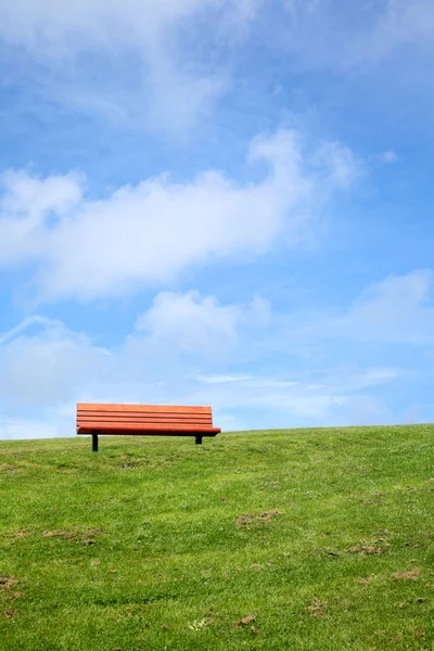 stock image Park bench with a big blue sky.