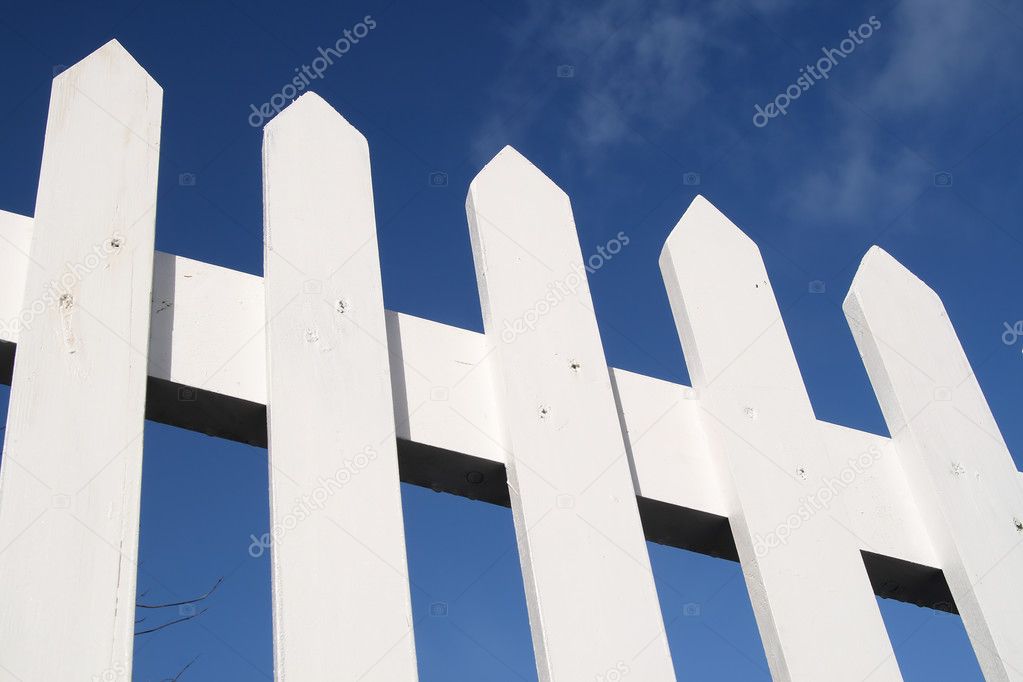 White picket fence and a blue sky.