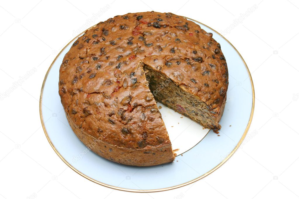 Fruit cake with a slice missing.