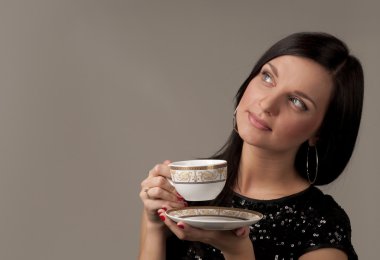 Young woman with a cup of tea clipart