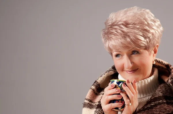 stock image Grand lady in plaid with cup