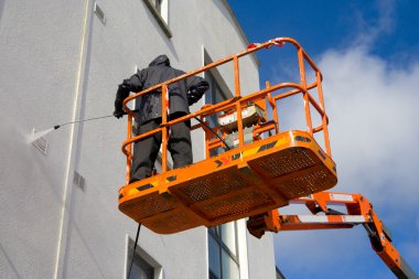 Woker washing a wall clipart