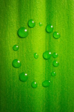 G-shape water drops on green leaf clipart
