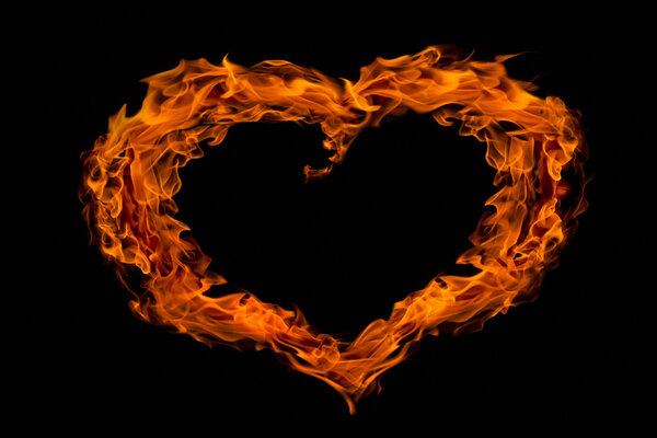 Heart shape fire flame collage isolated on black background