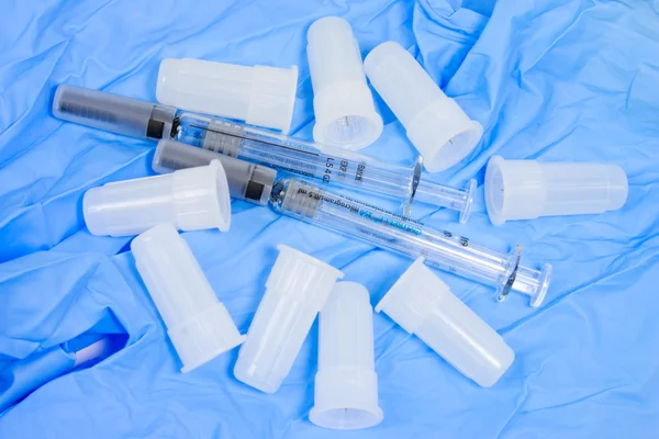 Syringe and needles with glove — Stock Photo, Image