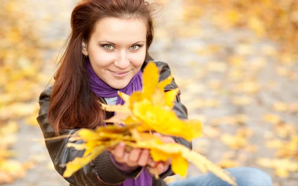 Portrait of young woman with yellow leav — Stock Photo, Image