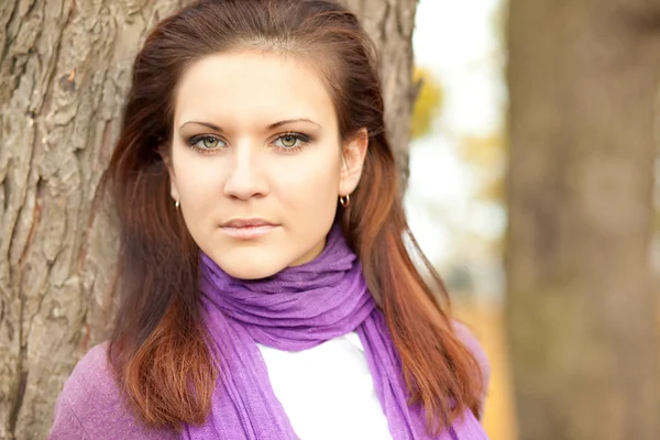 stock image Portrait of young woman in autumn park.