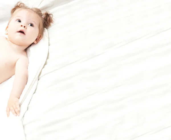 Baby girl in bed with copy space — Stock Photo, Image