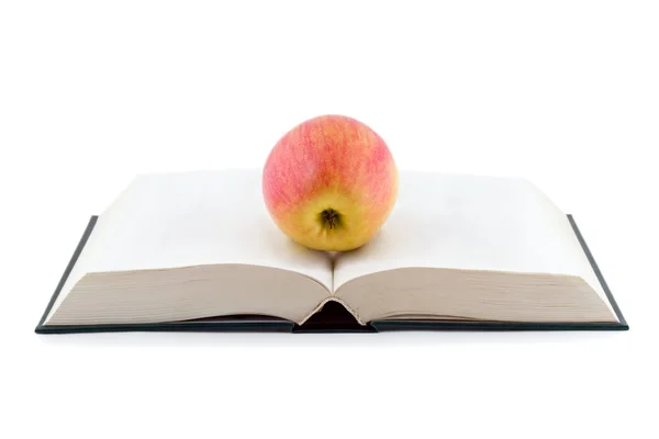 Apple on opened book — стокове фото