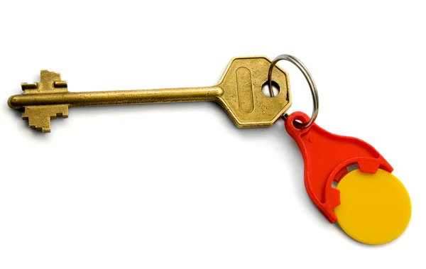 Der Schlüssel mit rotem Schlüsselanhänger für Münzen — Stockfoto