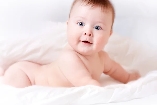 stock image Baby on white bedsheet