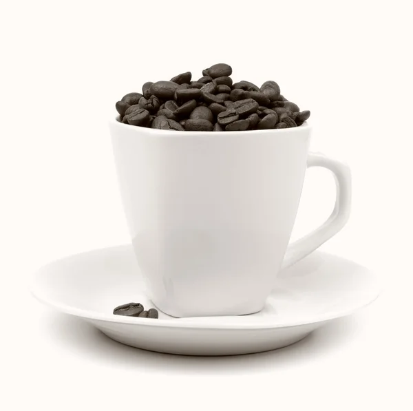 Cup and saucer with coffee beans — Stock Photo, Image