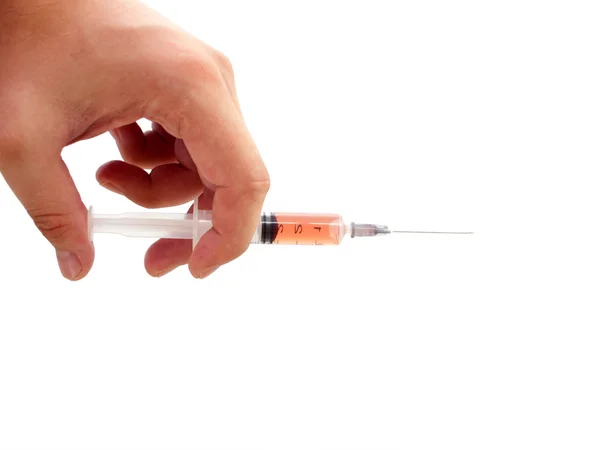 Filled syringe in a man hand. Stock Picture