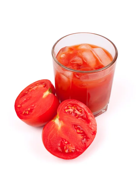 Tomater och juice i glas Stockbild