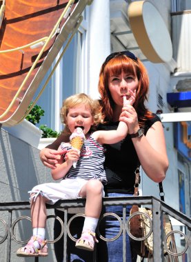 Mother and daughter eating an ice-cream clipart