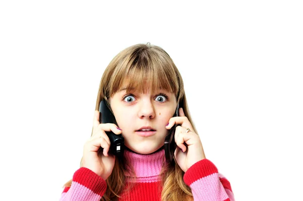 Menina chocada com dois telefones — Fotografia de Stock