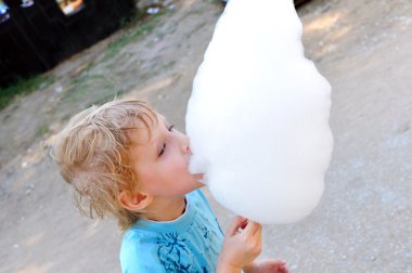 Boy eating cotton caddy clipart