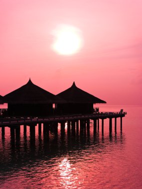 Water bungalows and sunset clipart