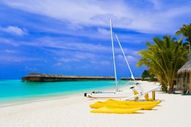 Yacht on tropical beach clipart