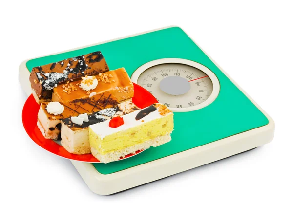 Cakes on weight scale — Stock Photo, Image