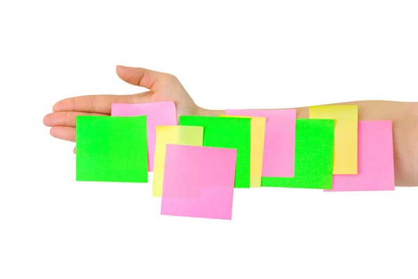 Mão e papel de nota multicolorido — Fotografia de Stock