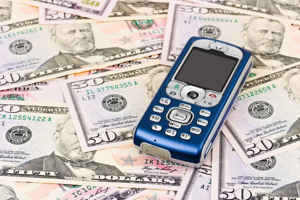 Mobile phone on money background — Stock Photo, Image