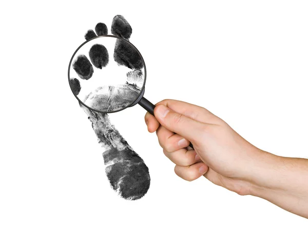 Magnifying glass in hand and foot printo — Stock Photo, Image