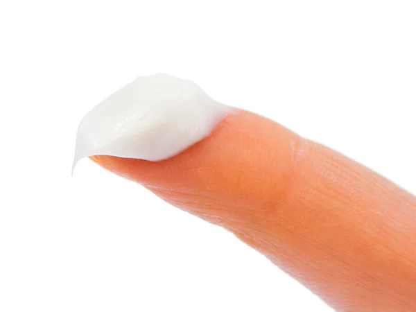 Woman finger and cream — Stock Photo, Image