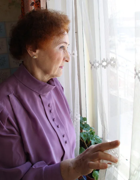 Woman looking outside — Stock Photo, Image
