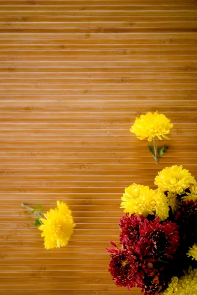 stock image Sparsed flowers on bamboo