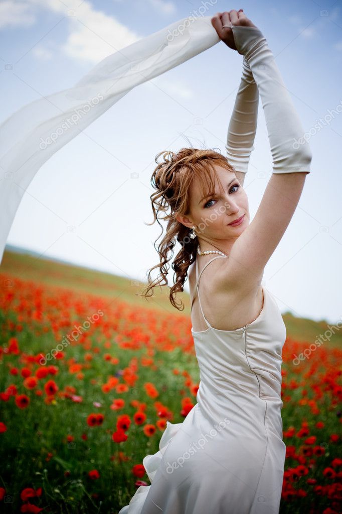 Beautiful woman in poppy field