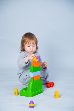 Child playing with bricks clipart