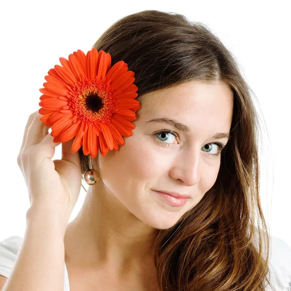 Beautiful woman with a bright red flower — Stock Photo, Image
