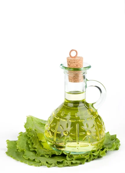 Cruet with oil on lettuce — Stock Photo, Image