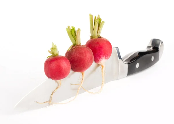 Radishes on knife blade — Stock Photo, Image