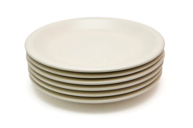 Stack of plain beige dinner plates clipart