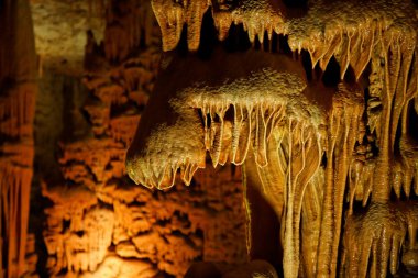 Stalactite in shape of paws in the cave clipart