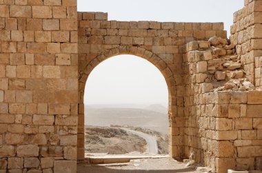 Ancient stone arch and wall in desert clipart