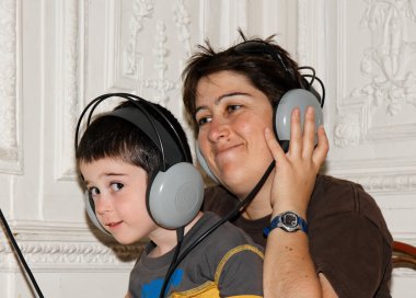 Mother and boy listen to music clipart