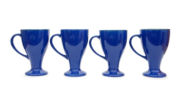 Fila de quatro copos de café azuis altos — Fotografia de Stock