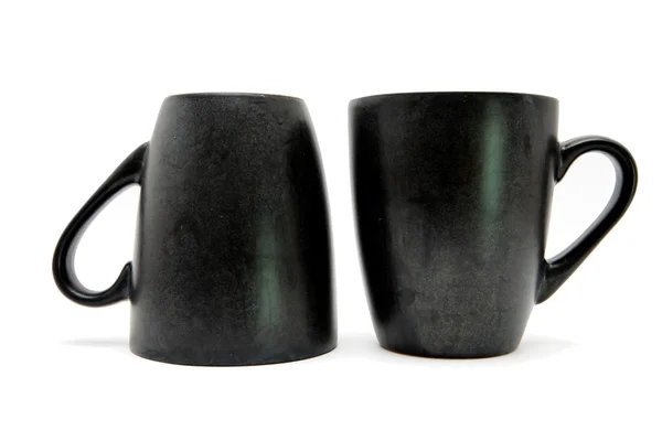 Due tazze di caffè nero su e giù — Foto Stock