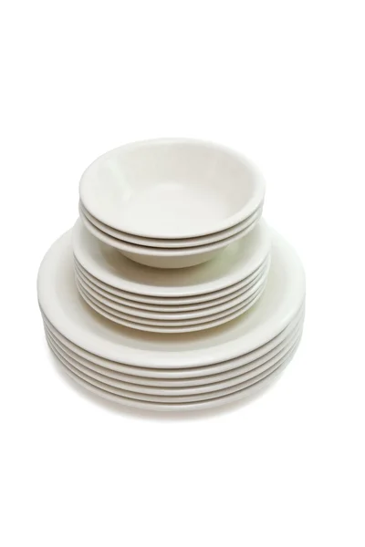 High stack of plain plates and saucers — Stock Photo, Image