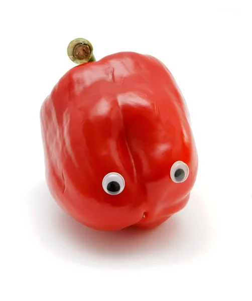 Sweet red bell pepper with eyes on white — Stock Photo, Image