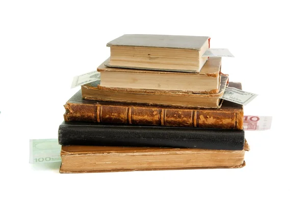 stock image Stack of old books with money bookmarks