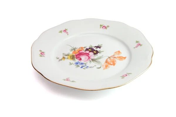 Белая тарелка с цветами — стоковое фото