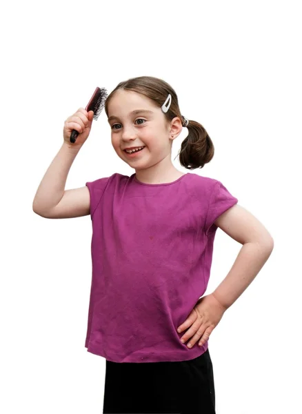 Cute girl with pigtails brushes her hair — Stock Photo, Image