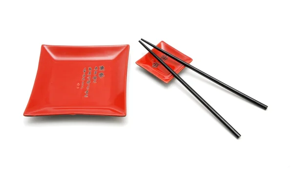 Chopsticks, prato quadrado vermelho e pires — Fotografia de Stock
