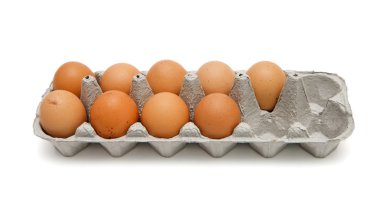 Nine brown eggs in a paper box isolated