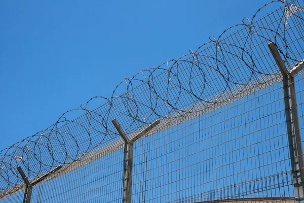 stock image Fence with spiral barbed wire on top
