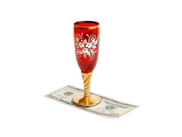 Copo de vinho vermelho e dourado em dólares — Fotografia de Stock